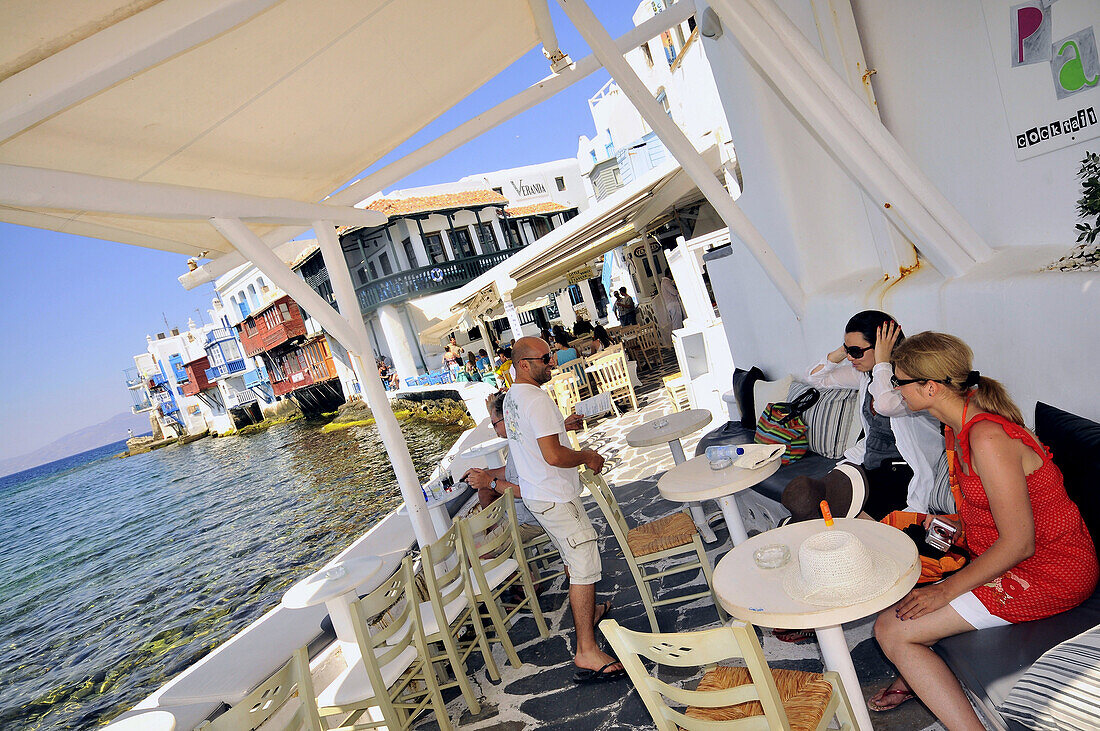 People at cafes at Venetia quarter, Mykonos island, Cyclades, Greece, Europe