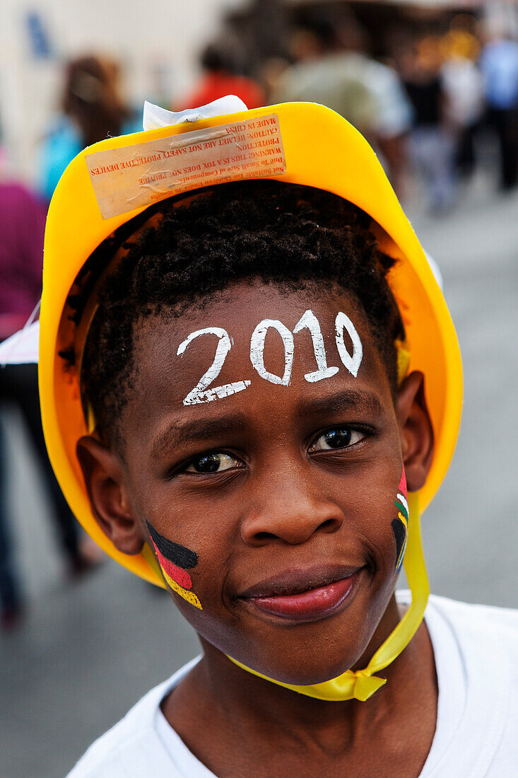 Boy celebrating the Football world cup final draw has a German flag and an African flag on his cheek, 04.12.2009, fans celebrate the drawing of the first round, Long street, Capetown, Western Cape, South Africa, Africa