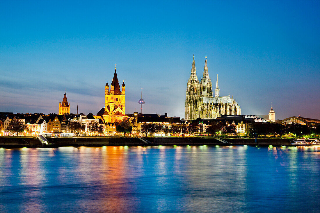 View over river Rhine to old town with cathedral and Great St. Martin church, Cologne, North Rhine-Westphalia, Germany