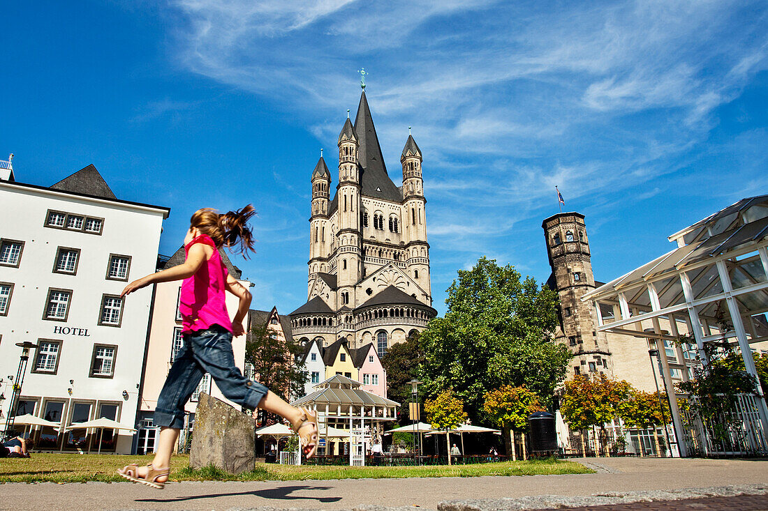 Fischmarkt and Great St. Martin church, girl in foreground, Old town, Cologne, North Rhine-Westphalia, Germany