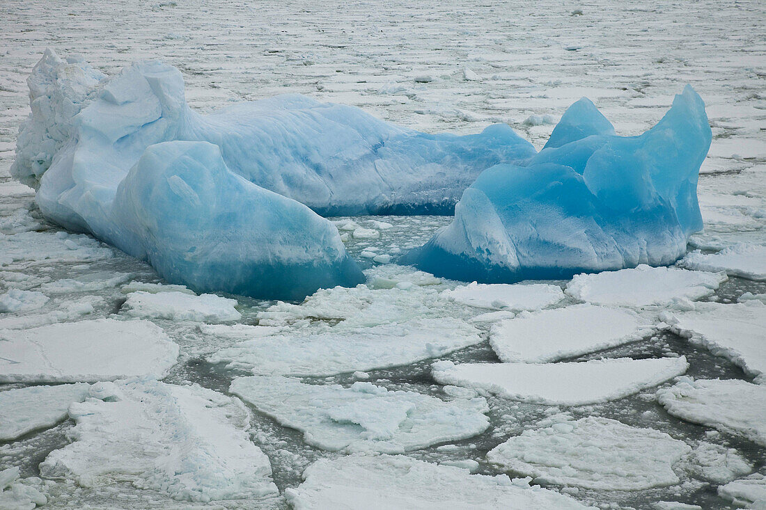 Blue iceberg in heavy pack ice,  northern Ross Sea