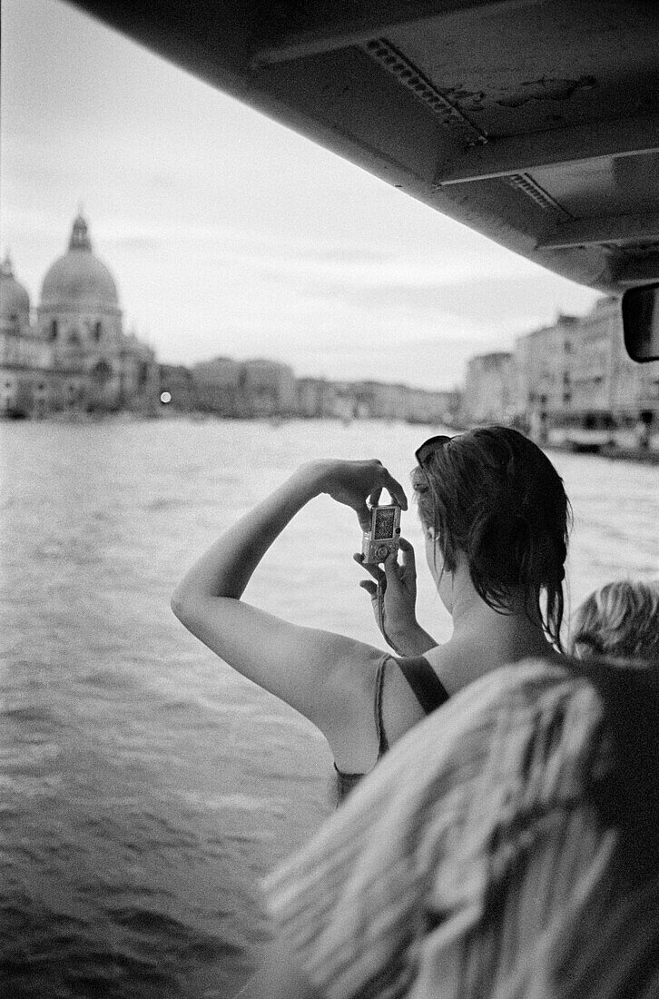 Adult, Adults, Architecture, b&w, back view, black-and-white, Camera, Cameras, Church, Churches, cities, city, Contemporary, Daytime, Digital camera, Dome, Domes, Europe, exterior, female, Hobbies, Hobby, Hold, Holding, holiday, holidays, human, Italy, Le