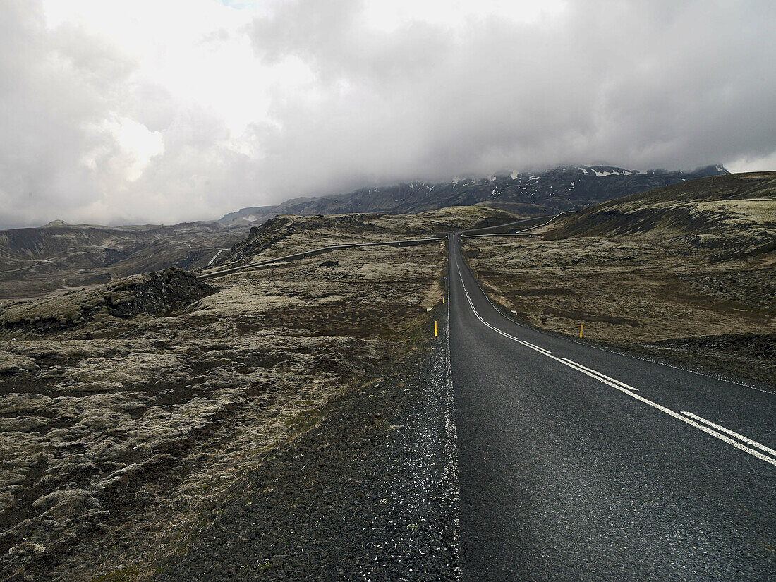 unmade road with fog on horizon