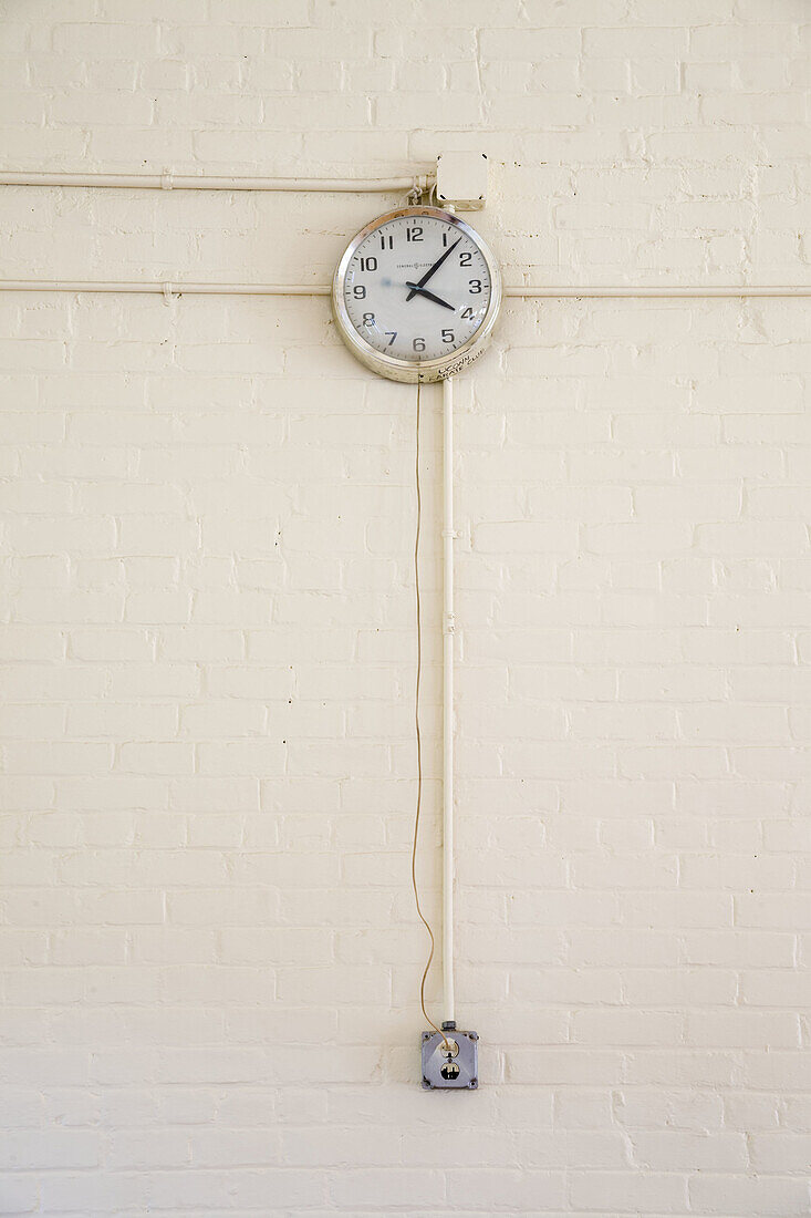 Clock plugged into an electrical outlet.