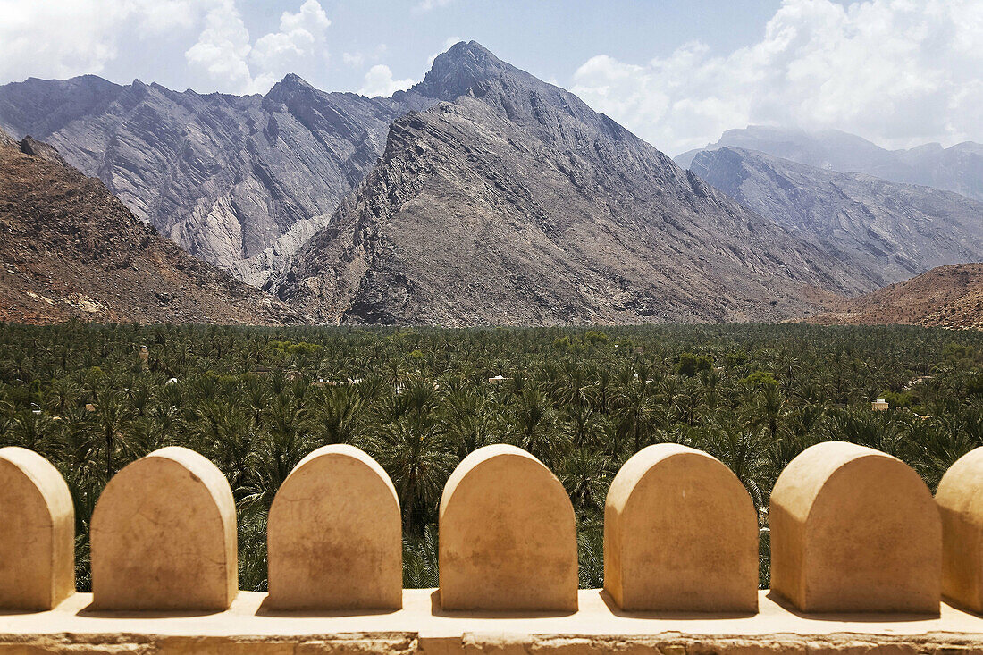 Detail of the fort walls in Fort Nakhl,  Nakhal,  Oman with a view of the Hajar Mountains in the background