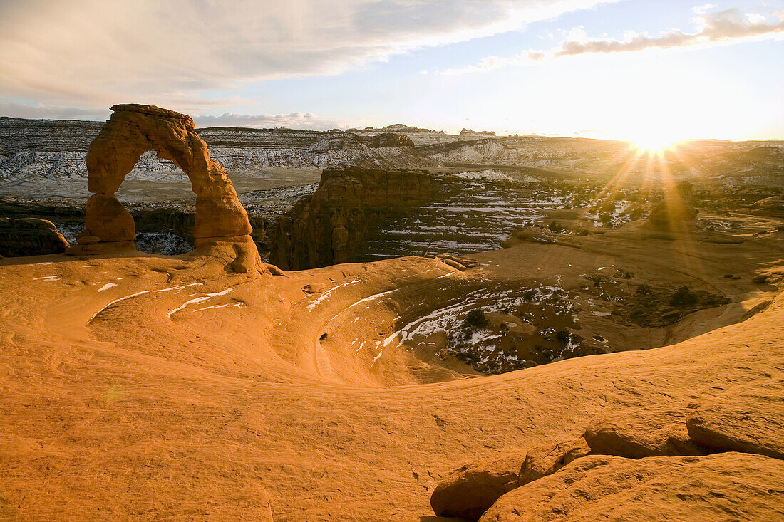 Delicate Arch basks in warm sunset glow on a cold winter afternoon,  Arches National Park,  Utah,  USA