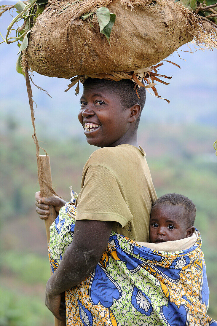 Woman and child,  carrying taro leaves,  Rwanda,  Africa