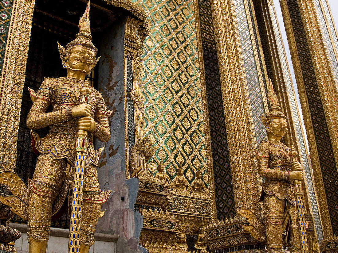 golden guardian statues at the Golden Palace in Bangkok Thailand