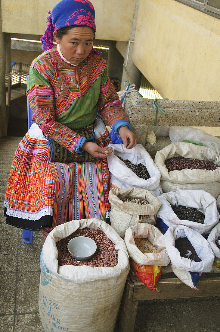 Flower Hmong woman selling beans in the market in Sapa Vietnam