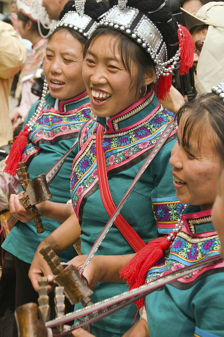 Hani women playing local instruments at the Long Table Festival in Yuanyang China