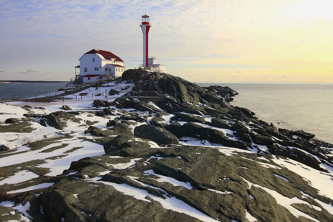 Winter scene with snow at Cape Forchu Lighthouse in Nova Scotia in Canada