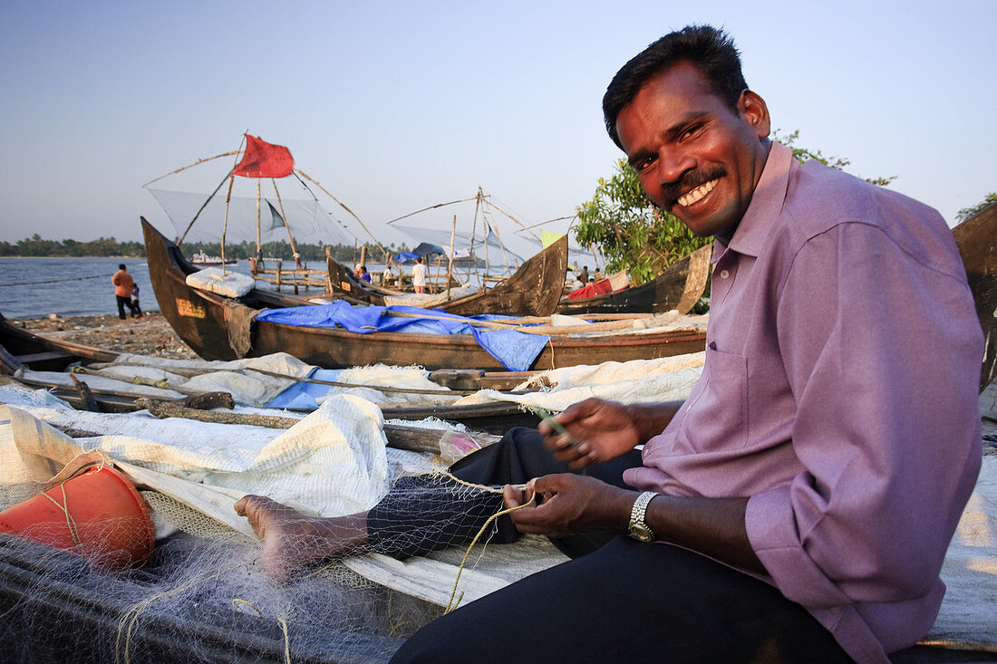 Fisherman working on a fishing net,  Fort Cochin,  Kerala