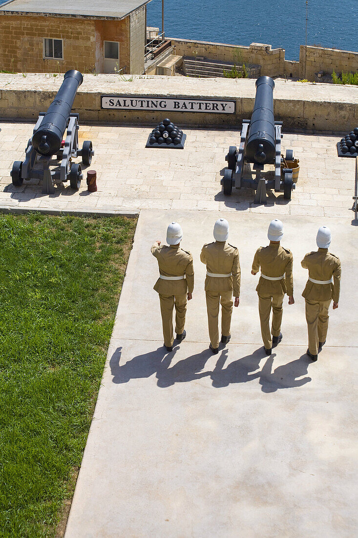 Soldiers marching towards cannons at the Saluting Battery,  Upper Barracca Gardens,  Valletta,  Malta