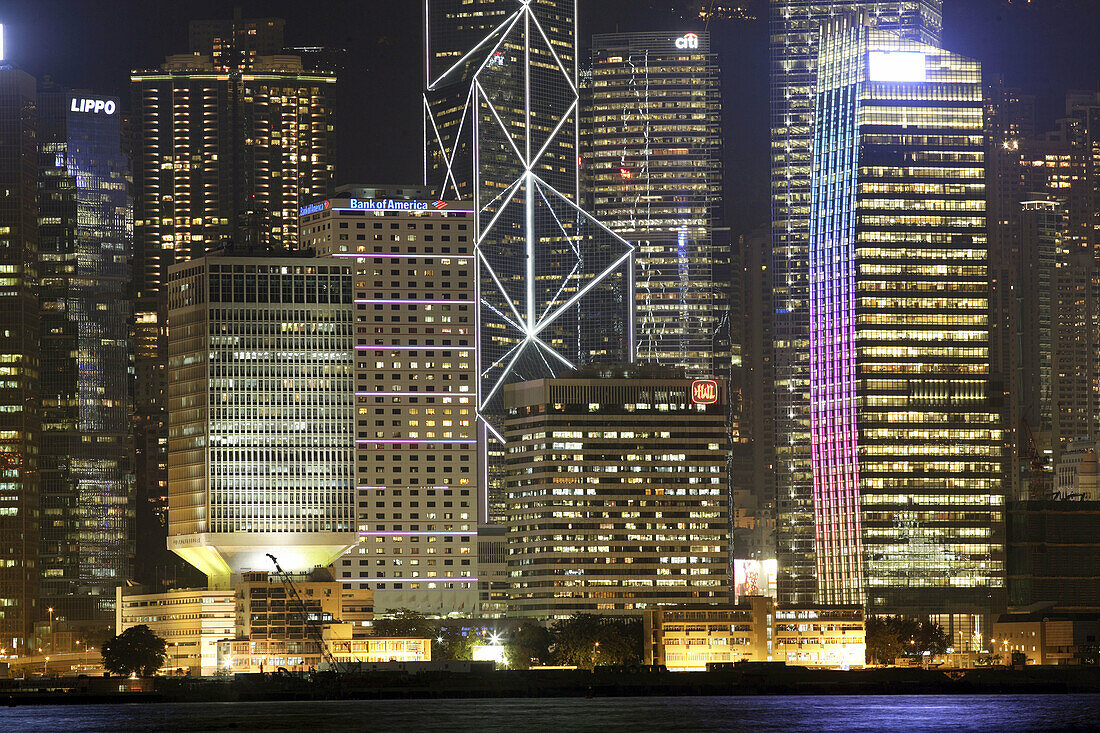 View across Hong Kong harbor to the colorful lights of the skyscrapers of Hong Kong Island in the night,  Hong Kong,  China,  Southeast Asia