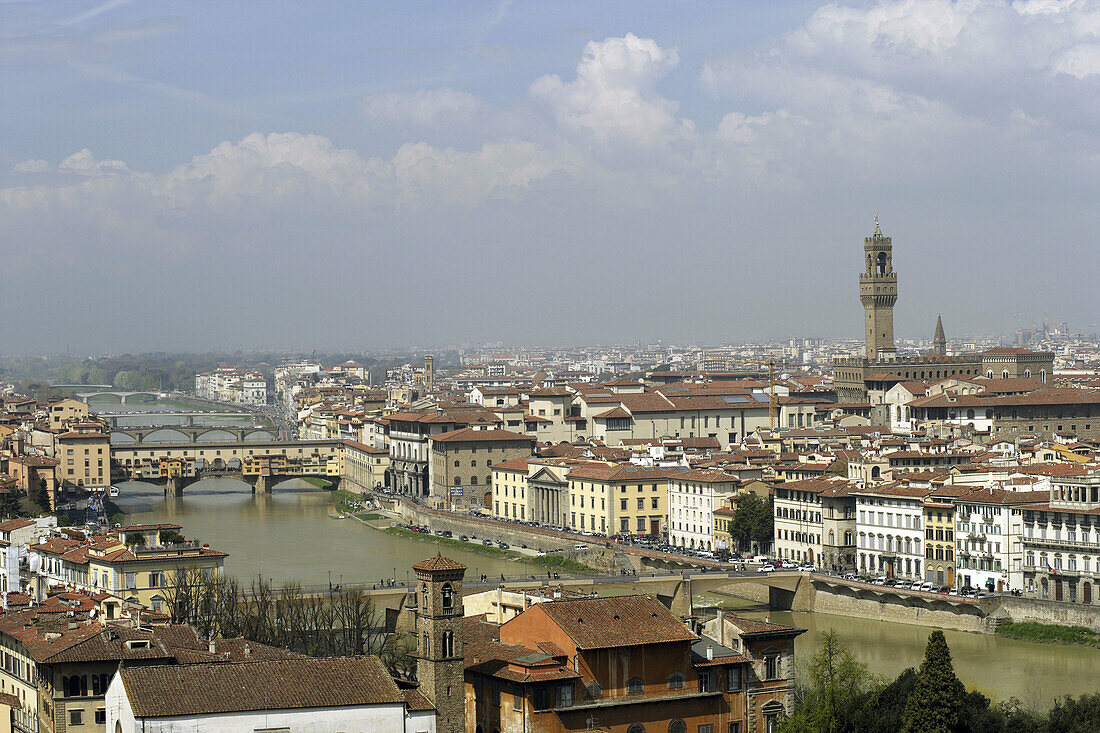 Aerial view of the old town of Florence with the Arno river and the Ponte Vecchio (Vecchio Bridge) with the bell tower of Palazzo Vecchio at a sunny day with blue sky and some couds,  Florence (Firence),  Tuscany,  Italy,  Southern Europe