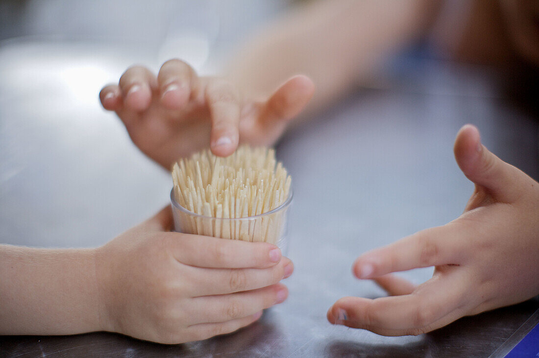 2008, Bar, Child, Children, Color, Colour, Comunidad Valenciana, Contemporary, Europe, Glass, Hand, Hands, People, Play, Playing, Point, Pointed, Prick, Proof, Prove, Spain, Table, Three, Tip, Toothpick, Valencia, L51-826324, agefotostock 
