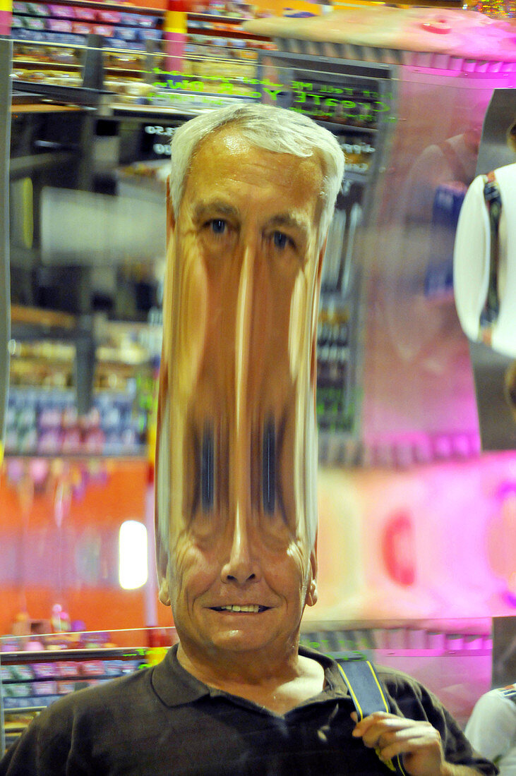 Man Sees Head in Distorted Fun Mirror Downtown Disney Orlando Florida,L54-871043 - © - Dennis MacDonald