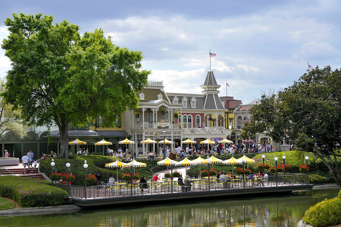 Cafe with yellow umbrellas at Walt Disney Magic Kingdom Theme Park Orlando Florida Central