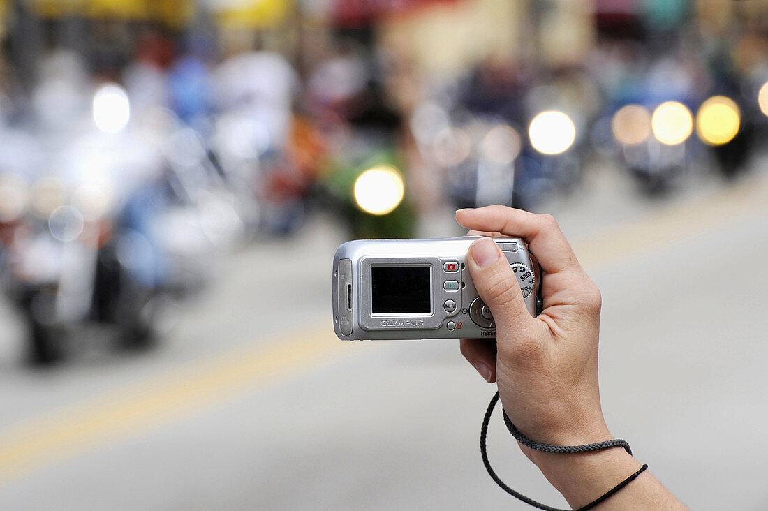 Daytona Beach Florida Biker Week motorcycle pilgrimage person taking picture with digital camera