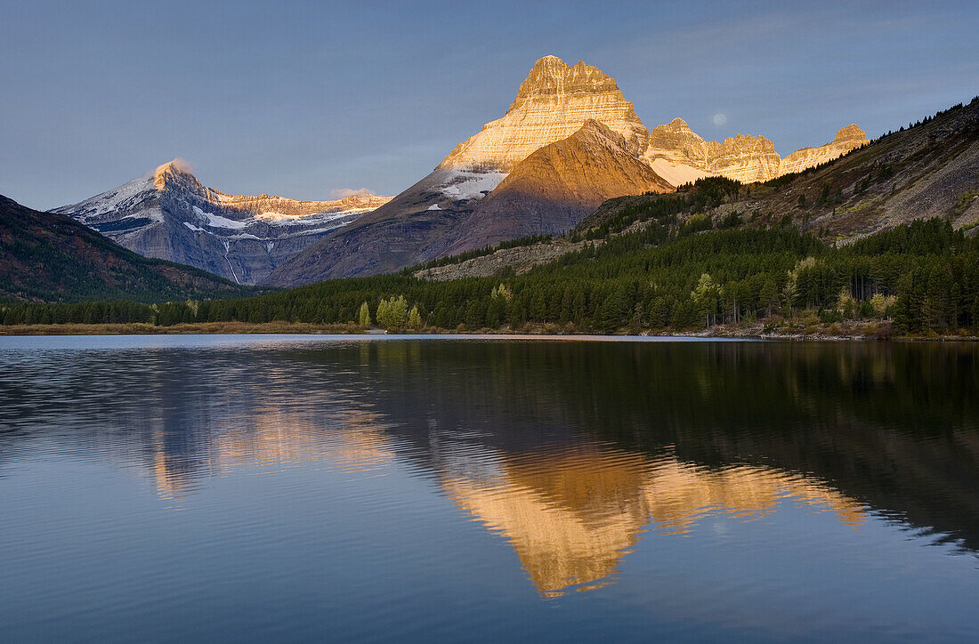 Dawn over Mount Wilbur 9, 321 ft 2, 841 m and Swiftcurrent Lake,  Glacier National Park Montana USA
