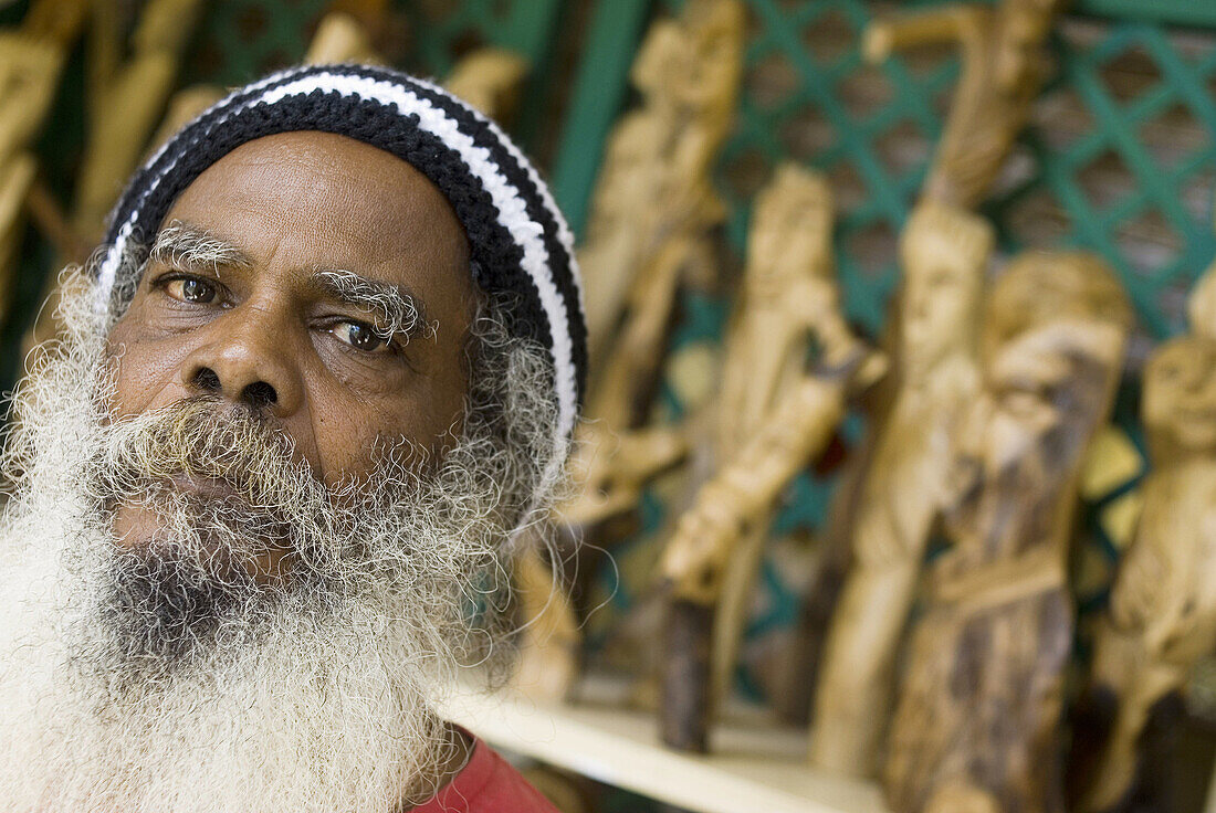 Wood carving artisan in Caudant Waterfront shopping area,  Port Louis,  Mauritius