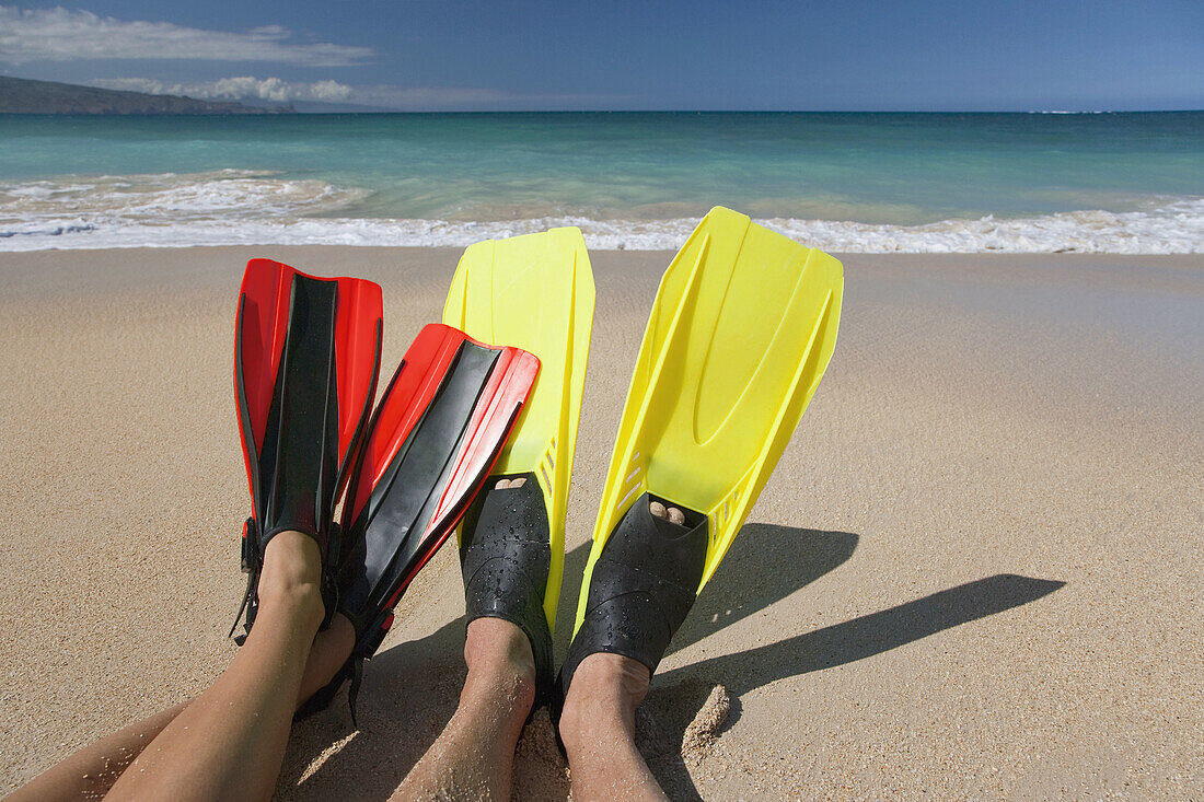 Couple wearing flippers on the beach  Maui,  Hawaii  Model released