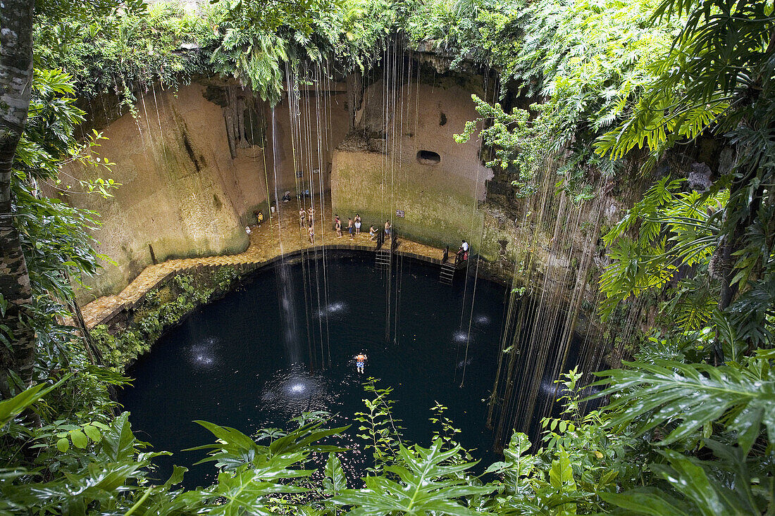 Mexico Yucatan Chichenitza People swimming at Ikil Cenote