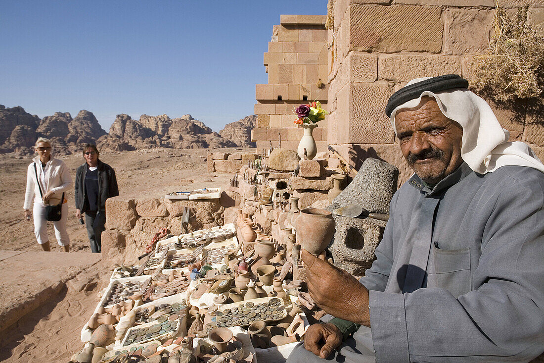 Jordan,  Petra Bedouin sells crafts at tombs,  besides tourists
