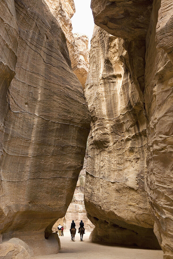 Jordan,  Petra,  the Siq Entrance to the city is through the Siq,  a narrow gorge,  over 1 kilometre in length,  which is flanked on either side by soaring,  80 metres high cliffs