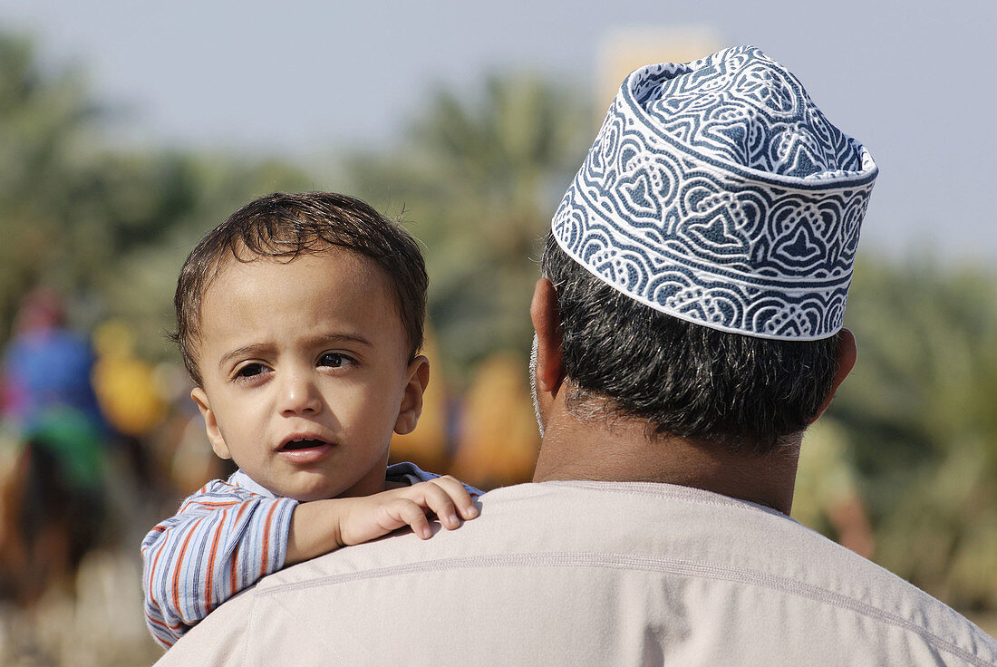 Omani father with son in traditional dress,  Nakhl,  Batinah Region,  Sultanate of Oman,  Arabia,  Middle East