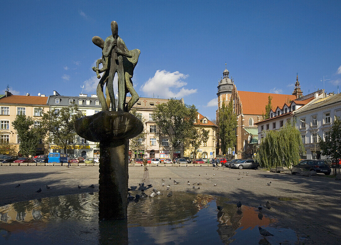 Poland Krakow Fountain and Corpus Christi Church at Wolnica Square,  Kazimierz district