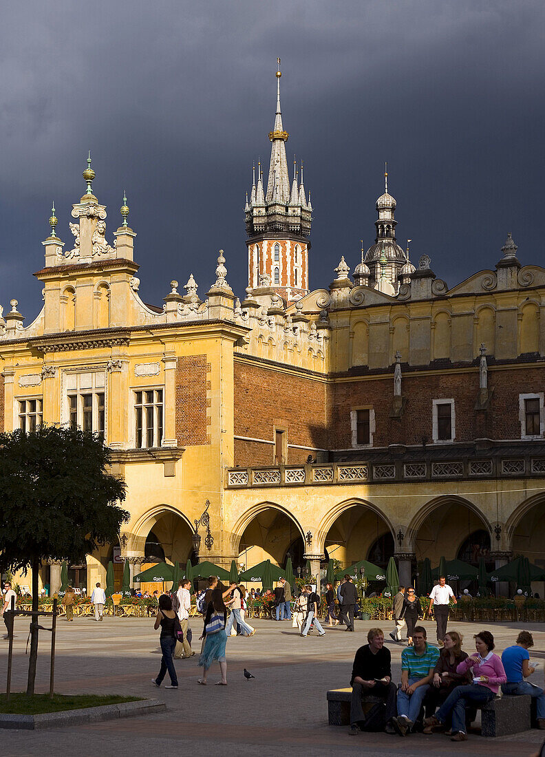 Krakow Poland Tourists by Cloth Hall  Sukiennice  and St Mary´s  Mariacki  Church at Main Market Square  Rynek Glowny  Old Town