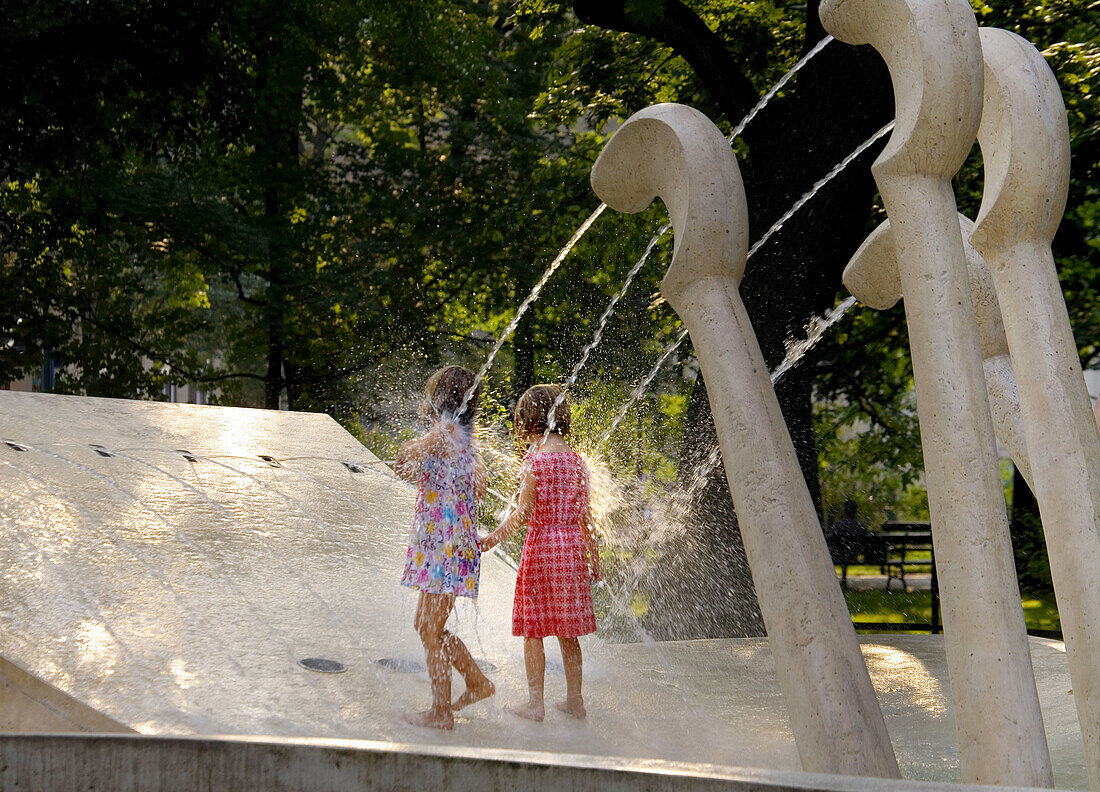 Poland,  Krakow,  Cooling off by fountain named ´Chopin´s piano´, Planty park,  summer