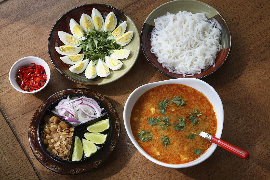 Myanmar,  Burmese Mohinga fish soup with side dishes