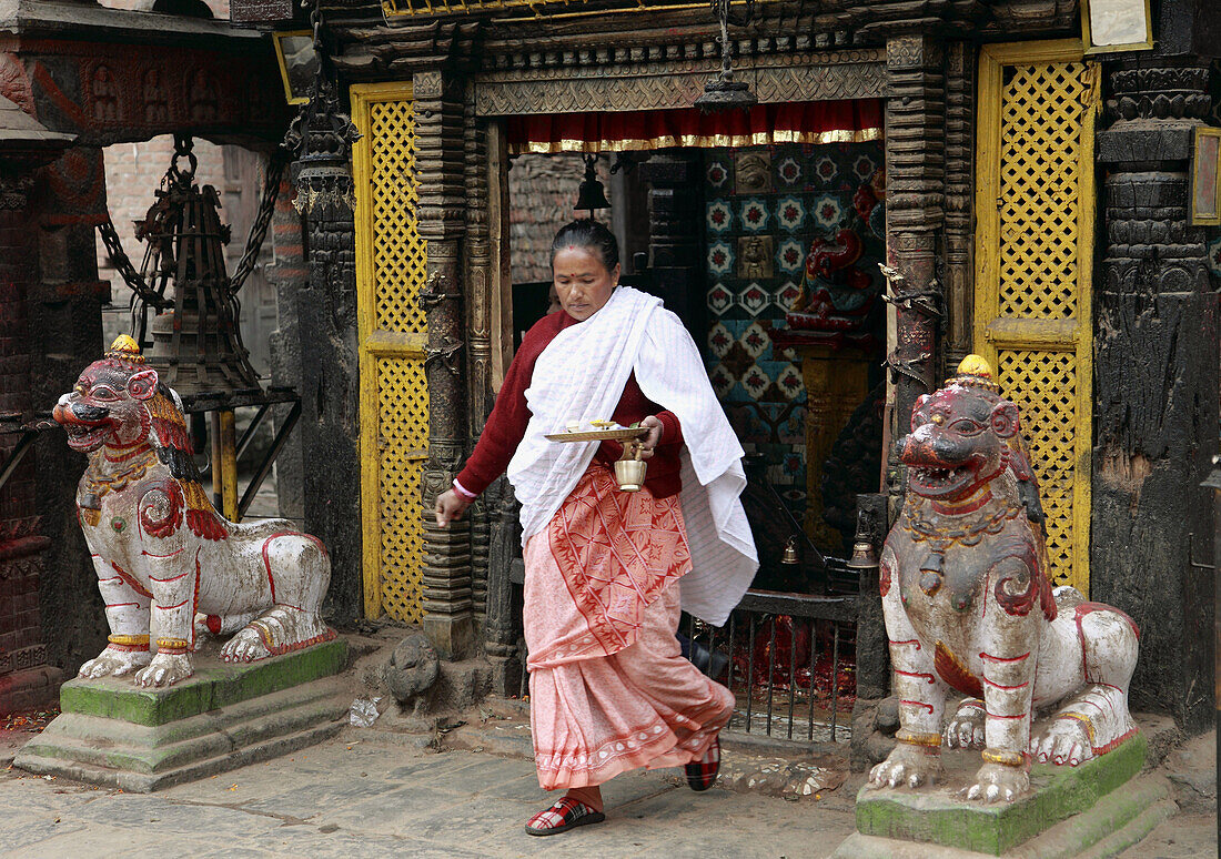 Nepal,  Kathmandu Valley,  Bhaktapur,  woman making religious ritual offering