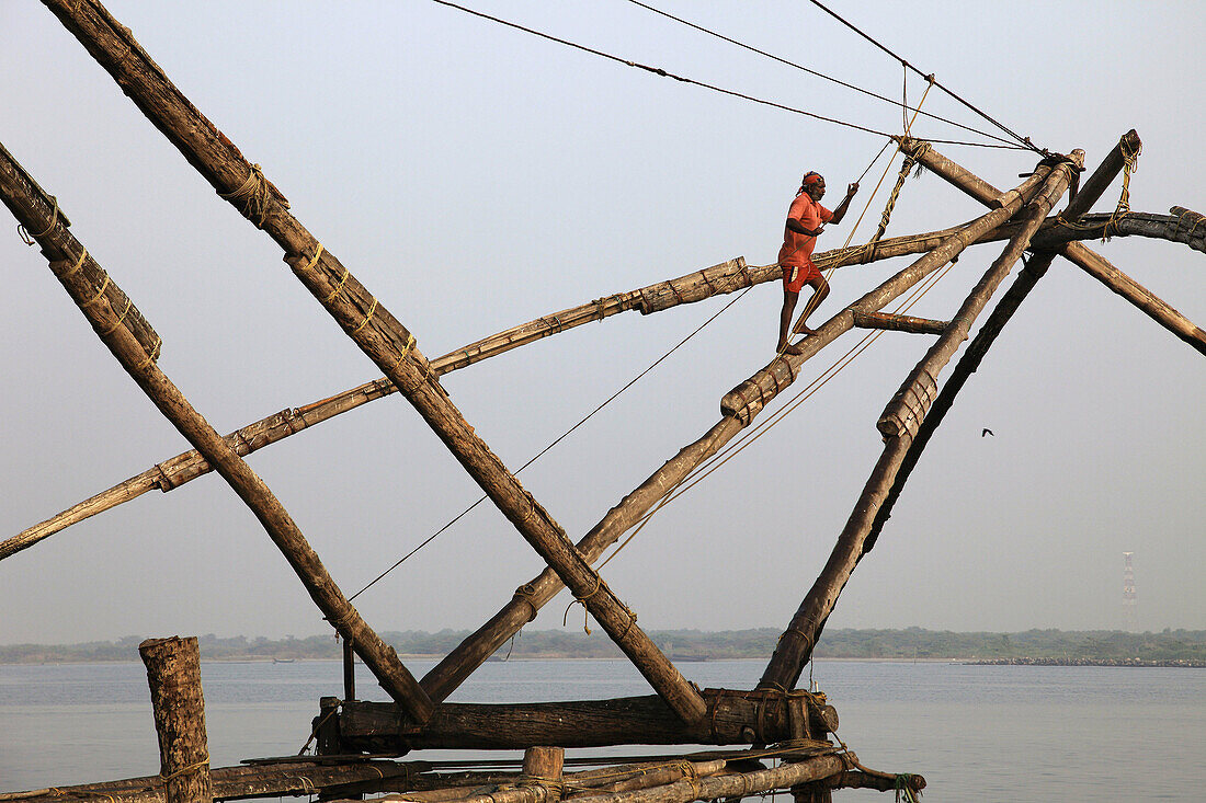 India,  Kerala,  Kochi,  Fort Cochin,  man working on chinese fishing nets