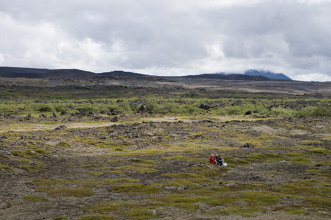 Hikers having a picnic in volcanic landscape, Krafla, Nordurland Eystra, Iceland, Europe