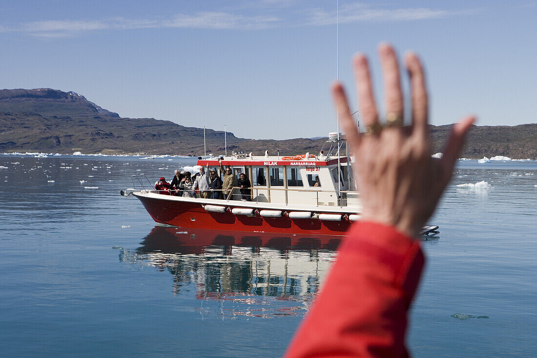 Waving hand and excursion boat at Qooroq Fjord, Narsarsuaq, Kitaa, Greenland