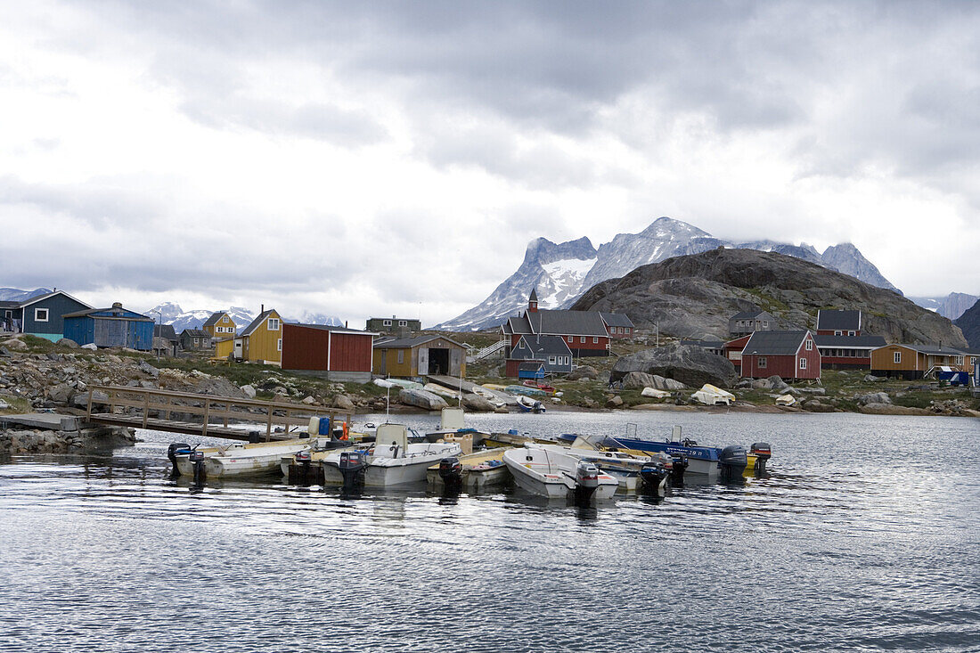 Fishing boats and Greenland's southernmost village under clouded sky, Augpilagtoq, Prince Christian Sound, Kitaa, Greenland