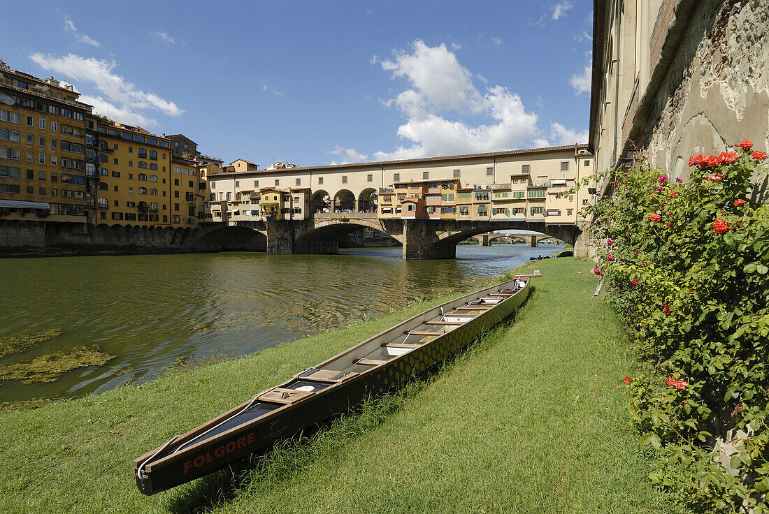 Florence Italy Rowing boat sitting on the bank of the Arno River,  Ponte Vecchio in the background