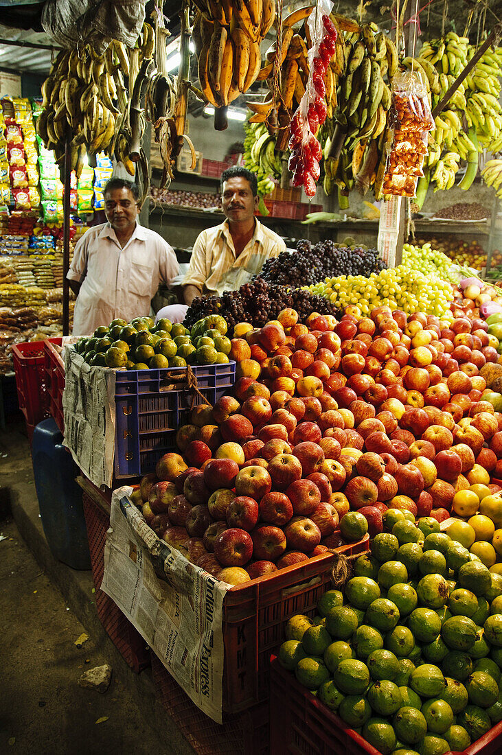Men standing in their fresh produce shop  Alleppy,  Kerala,  India