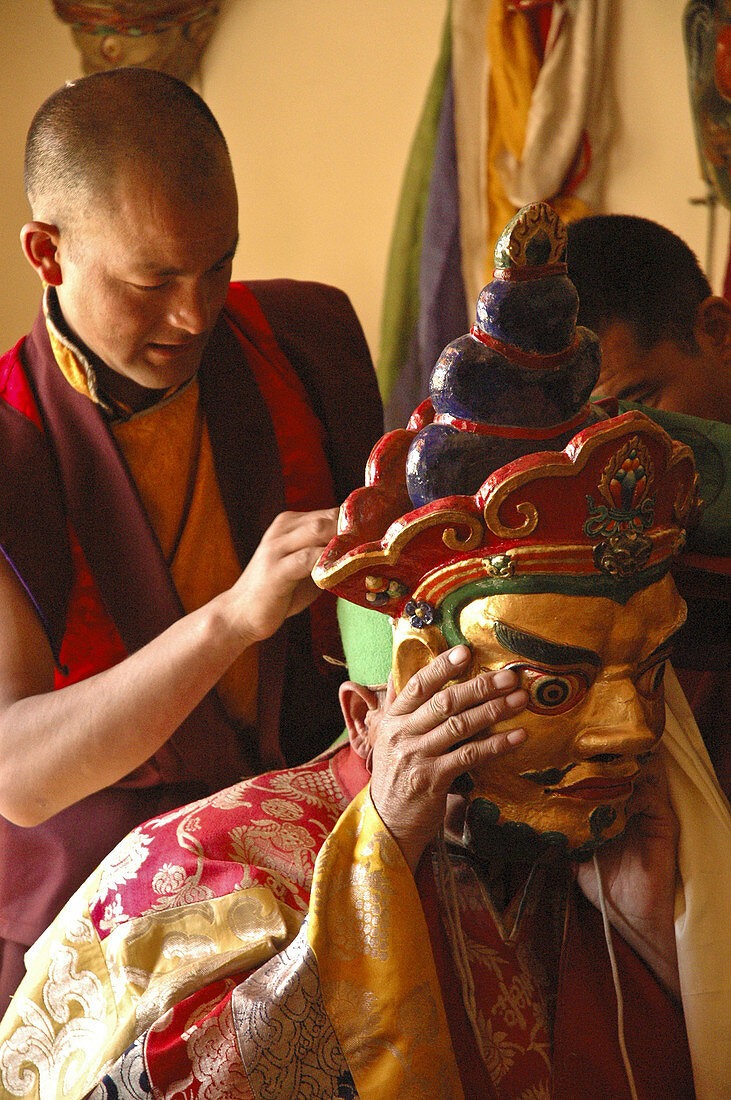 Monks dressing in the traditional mask for the festival at Lama Yuru monastery Ladakh,  India
