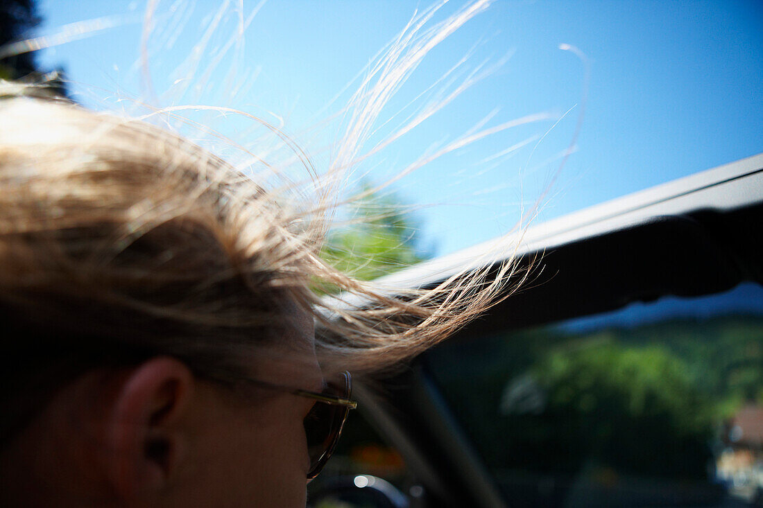 Woman riding a convertible, Black Forest, Baden-Wuerttemberg, Germany
