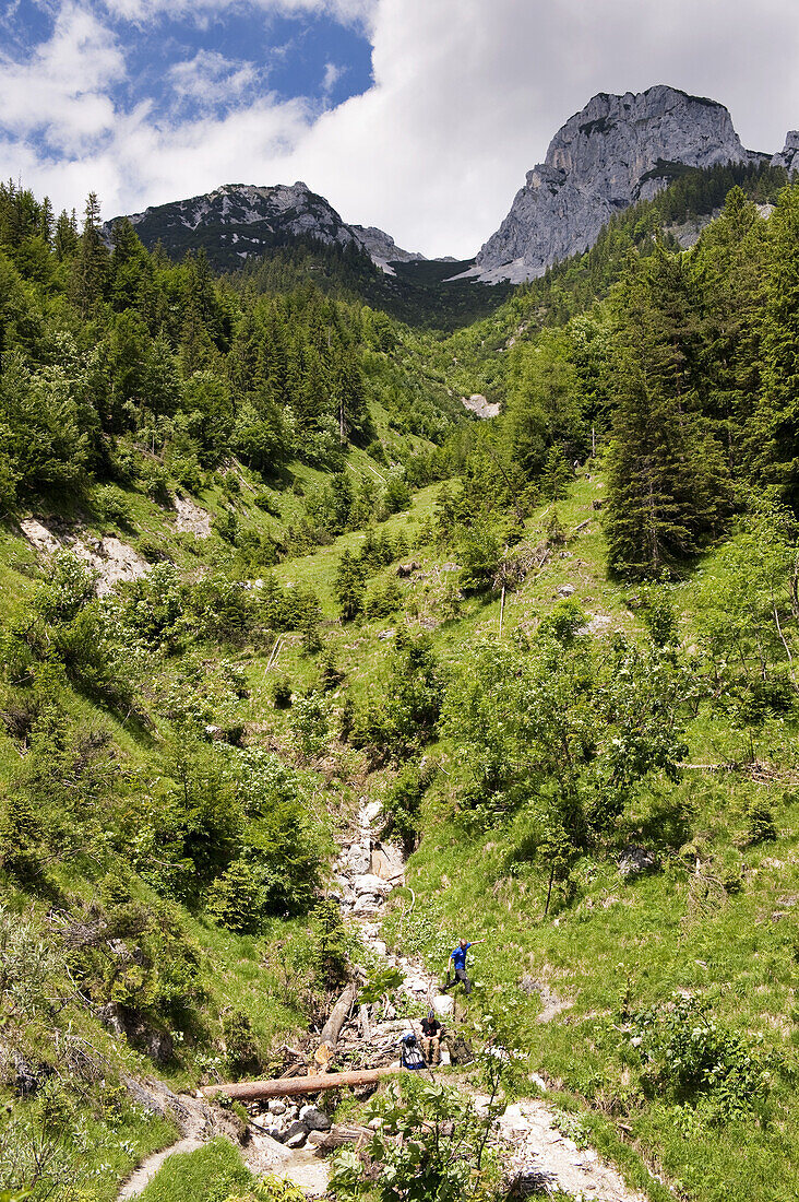 Hikers resting beside hiking trail, Kaisertal, Ebbs, Tyrol, Austria