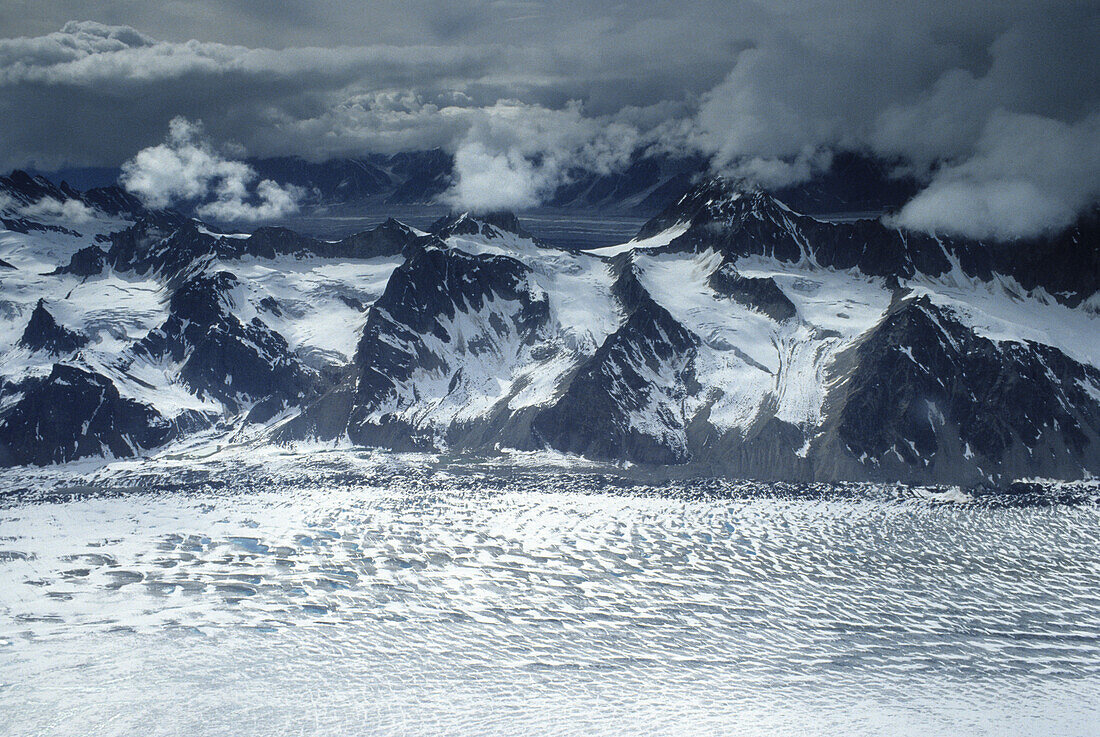 Aerial view of Tokositna Glacier under clouded sky, Alaska Range, Alaska, USA, United States of America