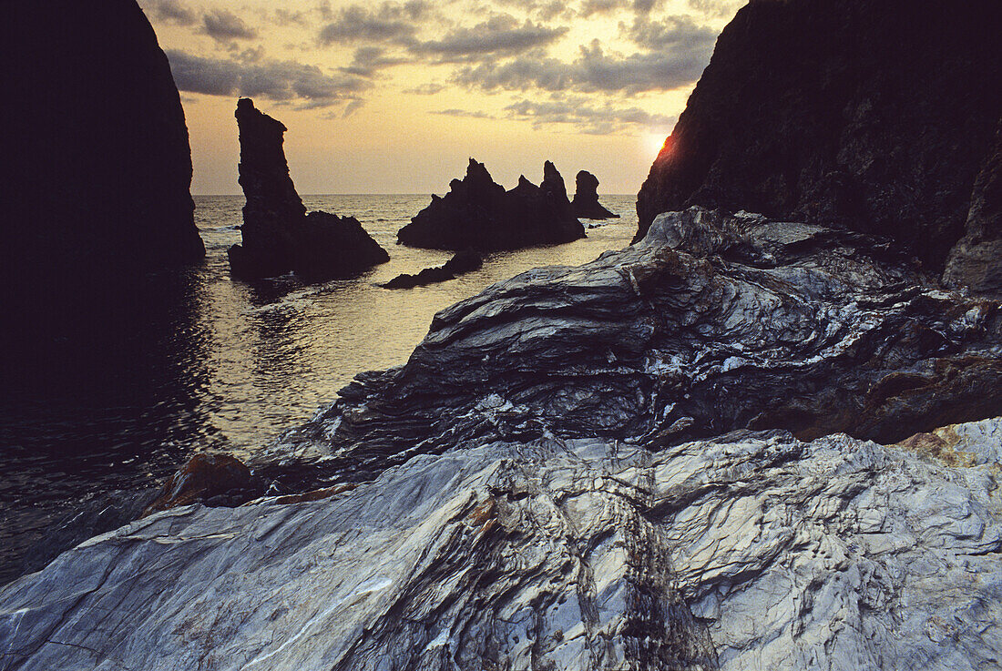 Rock formation Aiguilles de Port Coton at sunset, Belle Ile, Brittany, France, Europe