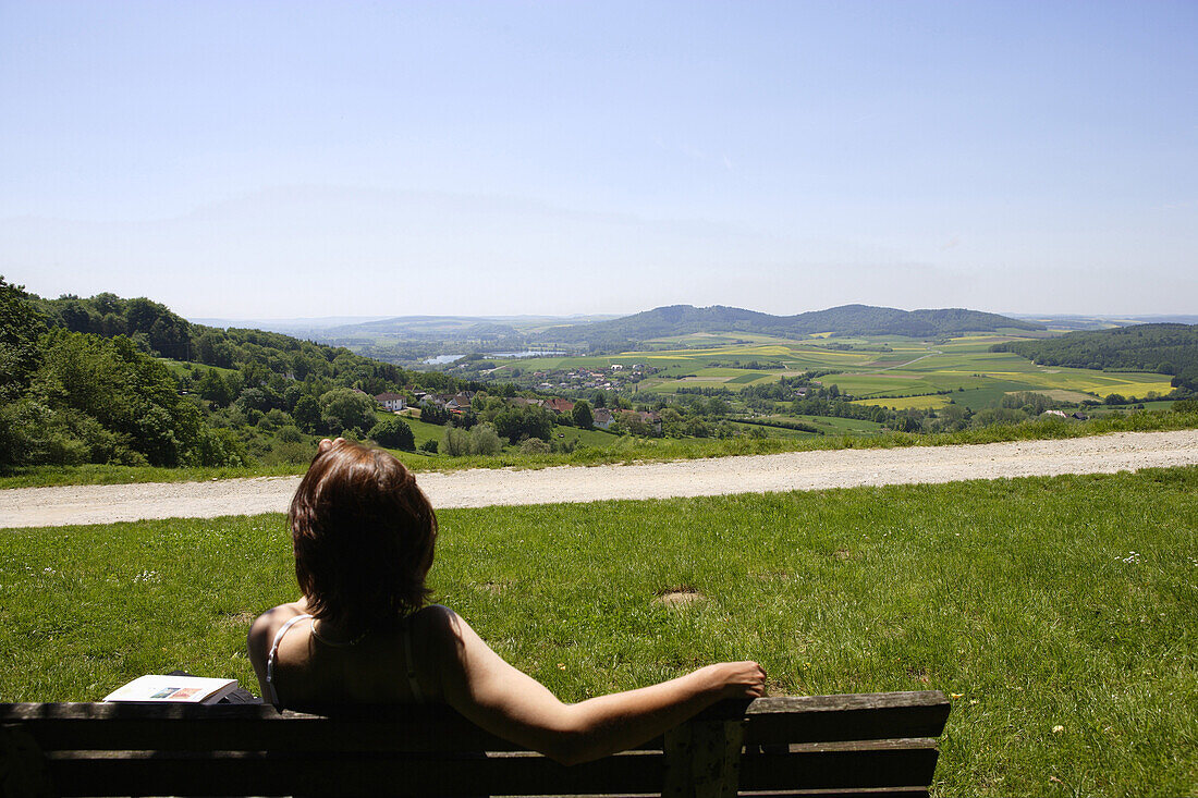Woman enjoying view over scenery near Bad Staffelstein, Franconia, Bavaria, Germany