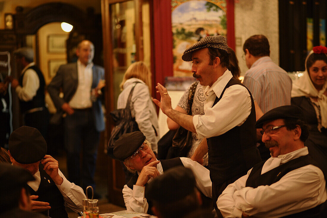 Group of men in a pavement cafe, Fiestas de San Isidro Labrador, Madrid, Spain