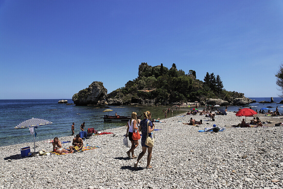 People sunbathing on sandbank near Isola Bella, Taormina, Sicily, Italy