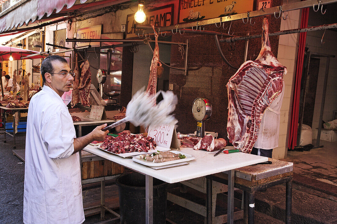 Butcher on fish market, Catania, Sicily, Italy